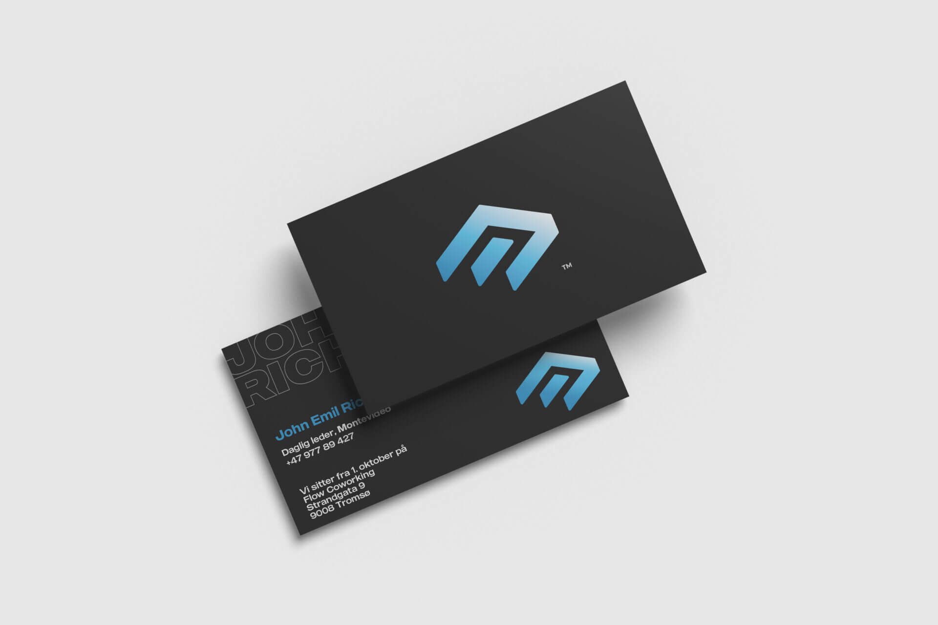 Two black Montevideo business cards with the blue logo