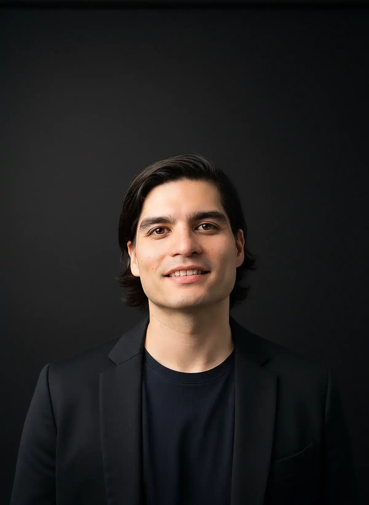 Matt Lok, digital marketing consultant, smiling in a black blazer against a dark background